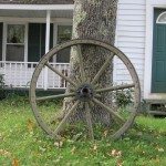 Wagon wheel on front lawn in Washington Village, Washington, Maine