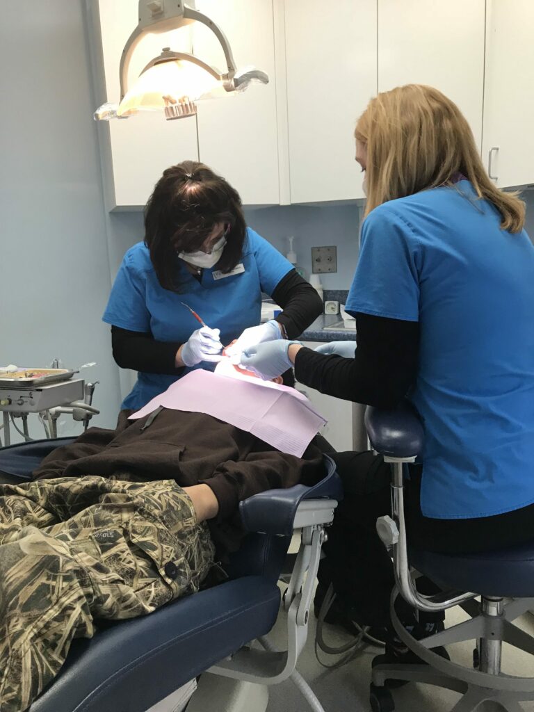 Michelle and Brenda working on Jarad's smile.