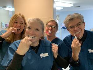 Camden, ME dental team learns how to brush their teeth.