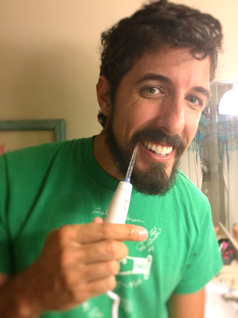 Photo op! Capturing Jason excitedly trying his Waterpik on his Invisalign buttons.
